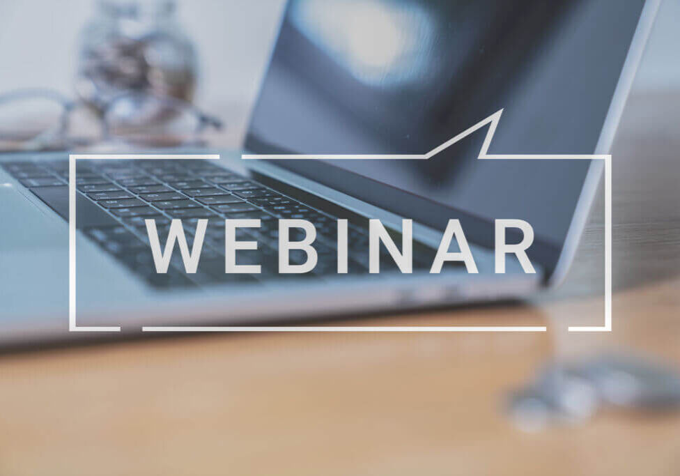 laptop with the word webinar imposed on top of the image